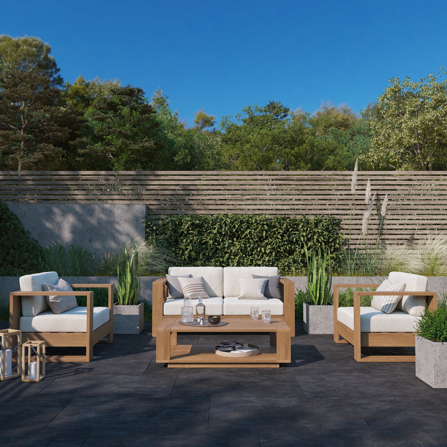 Basel outdoor sofa and lounge chair set in oiled eucalyptus, styled on a deck — Highbury Furnishings