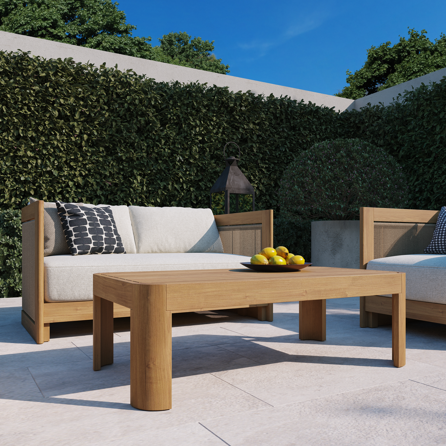 Cordelia 43-inch outdoor coffee table in washed oiled eucalyptus on a patio — Highbury Furnishings